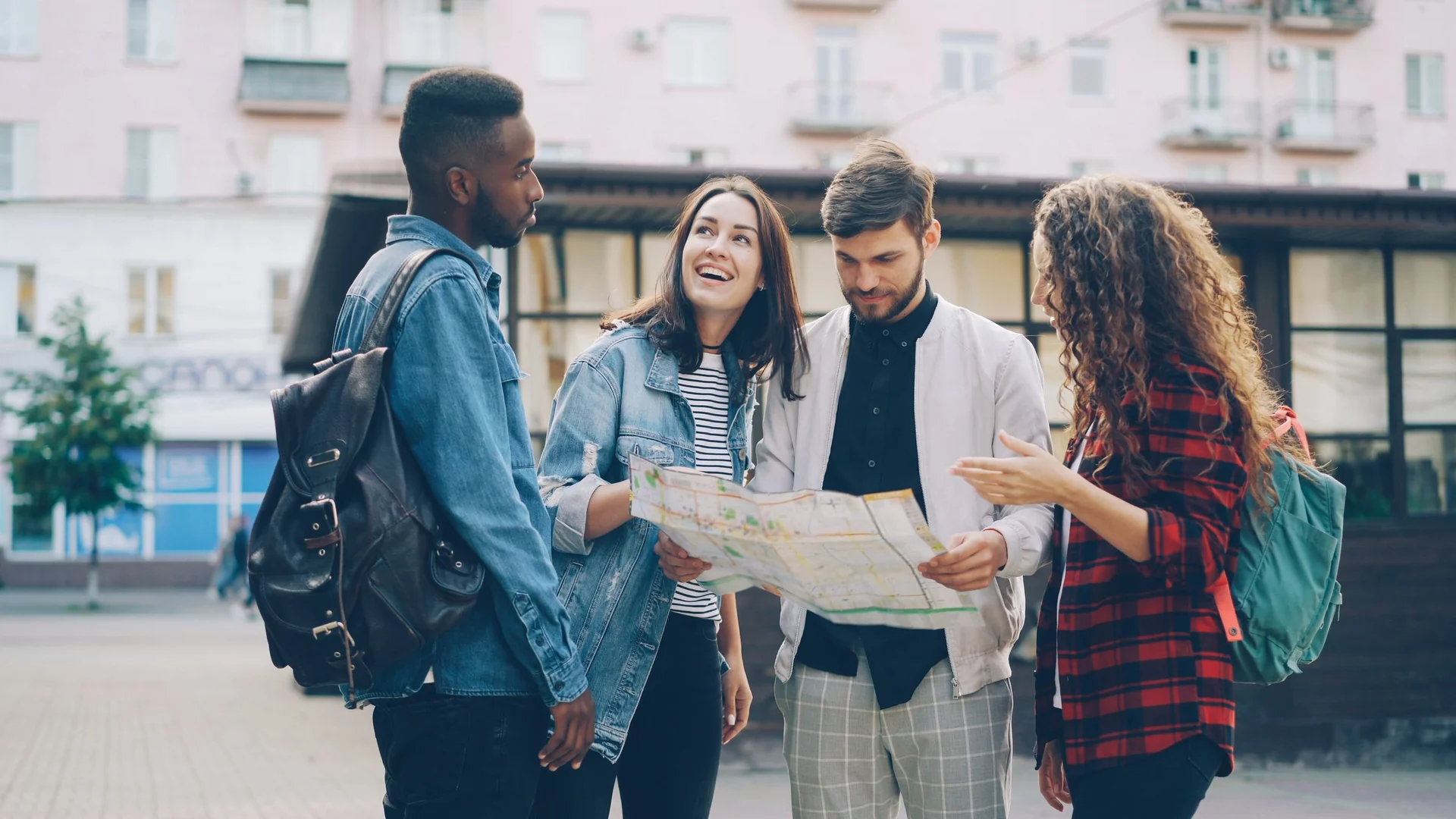 Group departures – friends exploring a city with a map