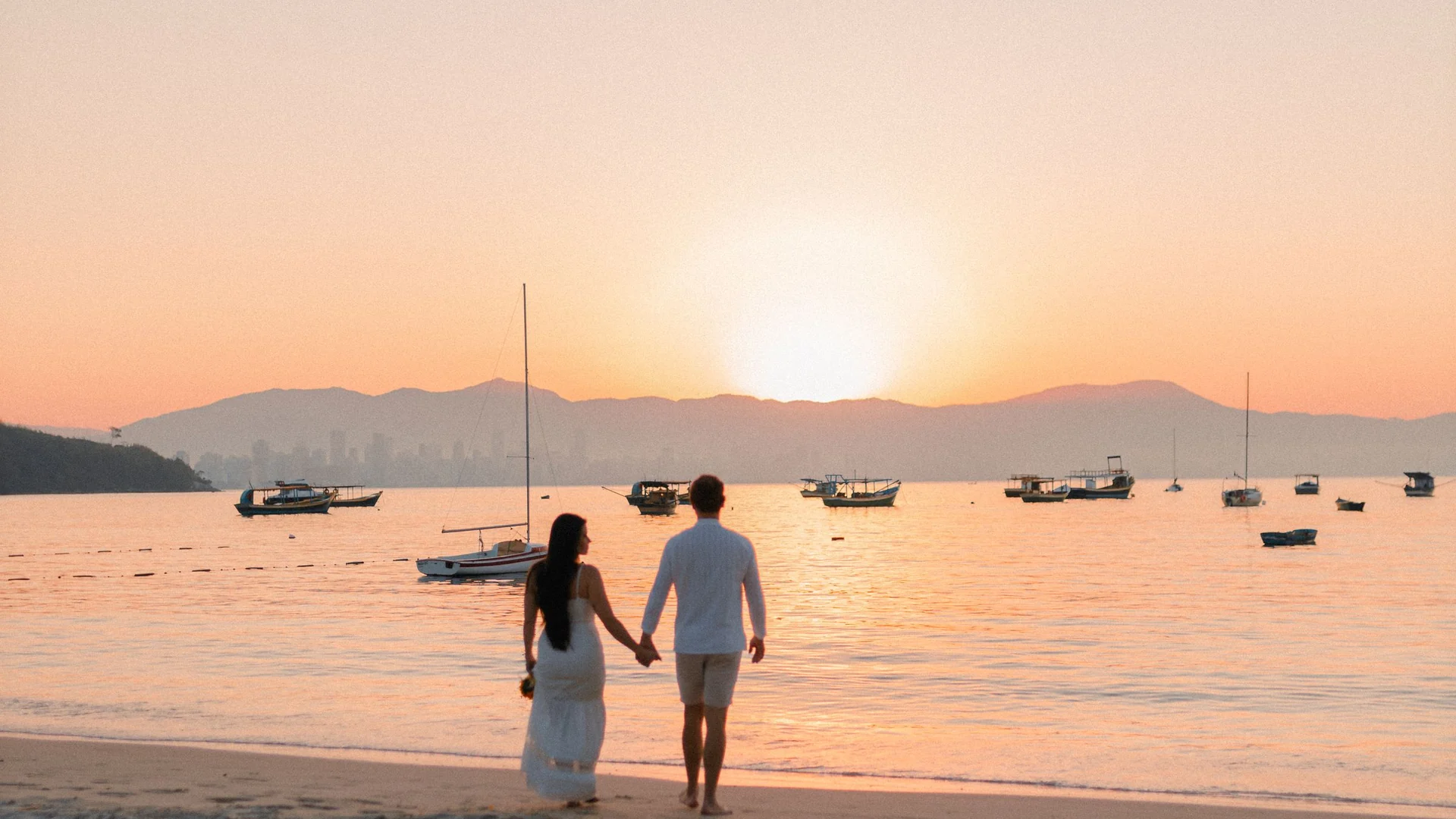 Honeymoon packages – couple on a beach at sunset
